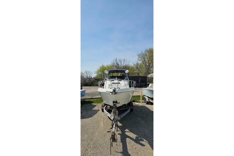 Slide: The Image of 2003 Caravelle 230 Walk Around Stern Drive boat on trailer, outdoors. - 3