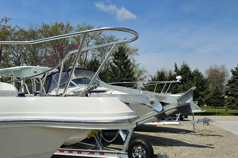 Slide: The Image of 2003 Caravelle 230 Walk Around Stern Drive boat on trailer, outdoors. - 4