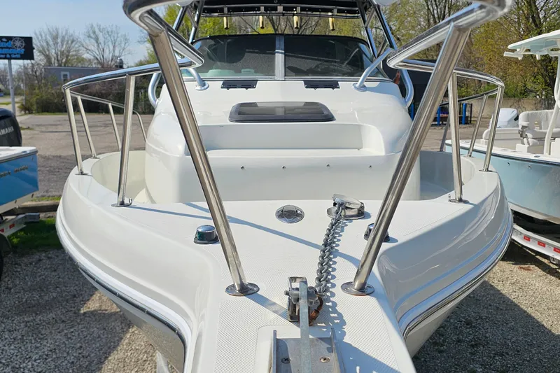 Slide: The Image of 2003 Caravelle 230 Walk Around Stern Drive boat, front view with stainless steel railings. - 5