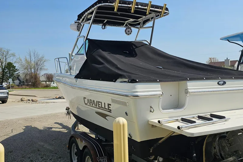 Slide: The Image of 2003 Caravelle 230 Walk Around Stern Drive boat on trailer, covered and parked outdoors. - 7