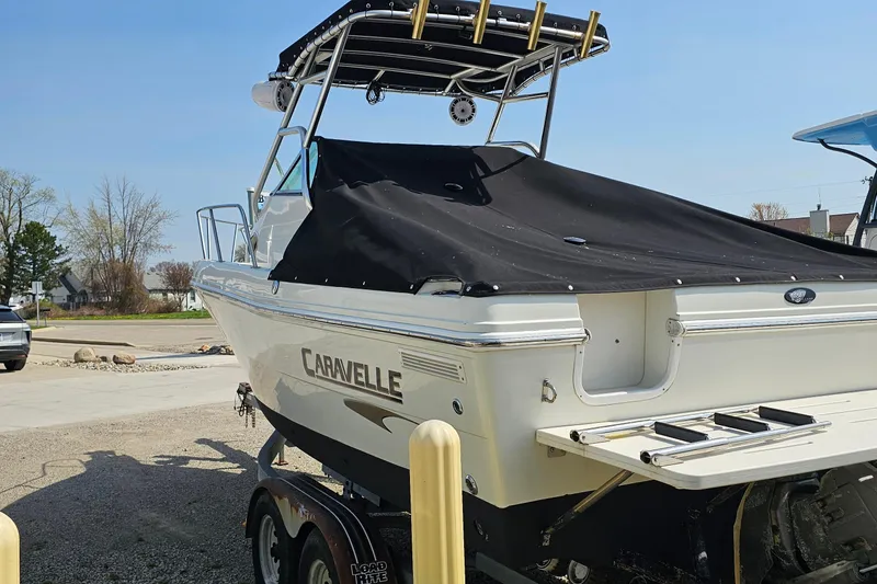 Slide: The Image of 2003 Caravelle 230 Walk Around Stern Drive boat on trailer, covered and parked outdoors. - 8