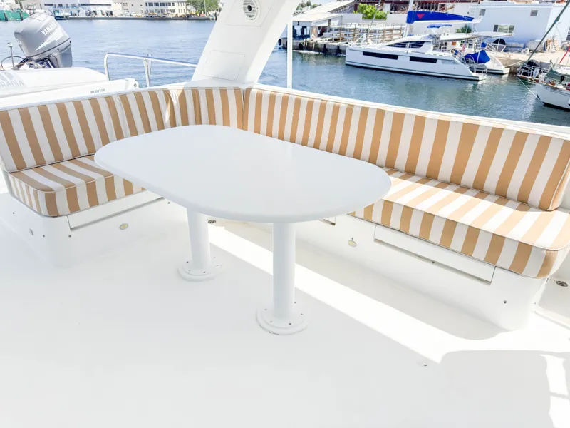 Slide: The Image of Cheoy Lee 68 Motor Yacht 2004 with striped seating and table. - 13