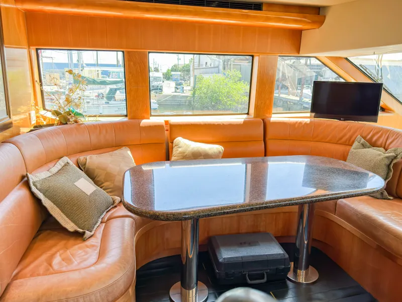 Slide: The Image of Interior of a 2004 Cheoy Lee 68 Motor Yacht with leather seating area. - 19