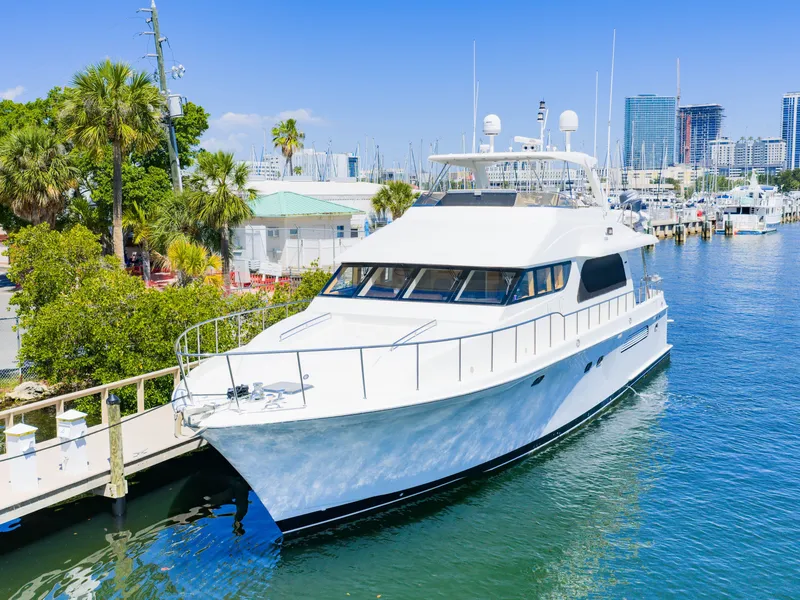 Slide: The Image of 2004 Cheoy Lee 68 Motor Yacht docked in marina with palm trees. - 3