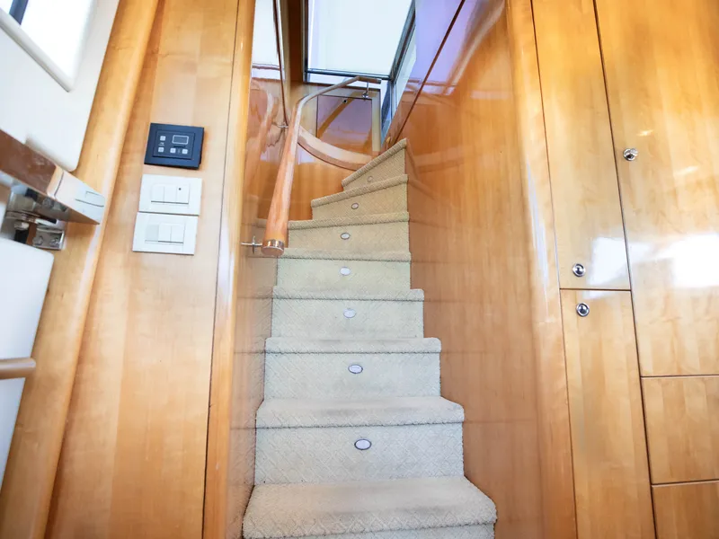 Slide: The Image of Interior of 2004 Cheoy Lee 68 Motor Yacht, featuring wooden staircase. - 32