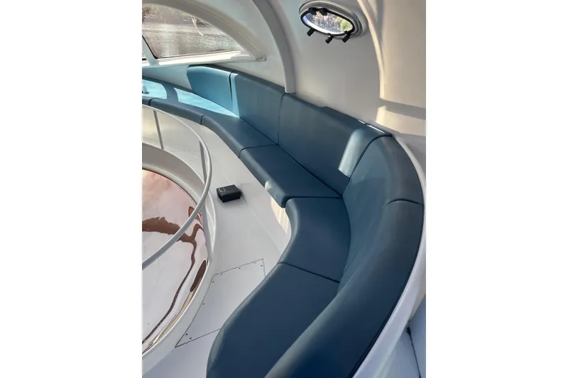 Slide: The Image of Interior of 2020 Paritetboat Looker with curved seating and porthole window. - 13