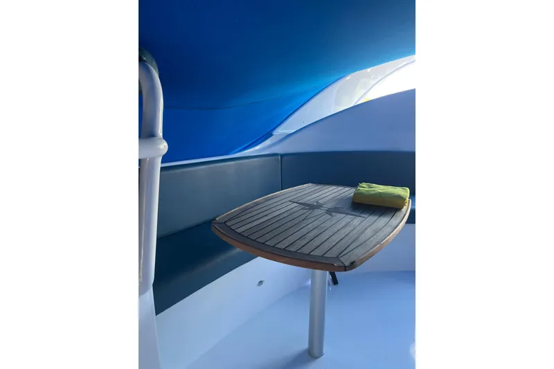 Slide: The Image of Interior of 2020 Paritetboat Looker with wooden table and blue seating. - 7