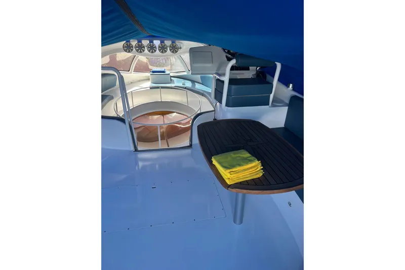 Slide: The Image of Interior of 2020 Paritetboat Looker with seating, table, and yellow towels. - 8