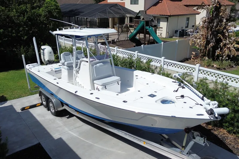 The Image of 2019 Blue Wave 2800 Pure Hybrid boat on trailer in residential driveway. - 0