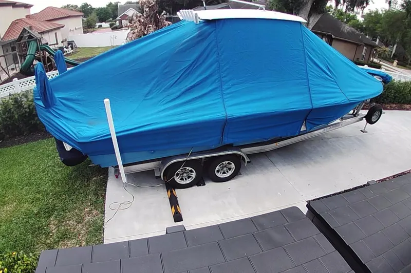 Slide: The Image of Covered 2019 Blue Wave 2800 Pure Hybrid boat on trailer in driveway. - 26