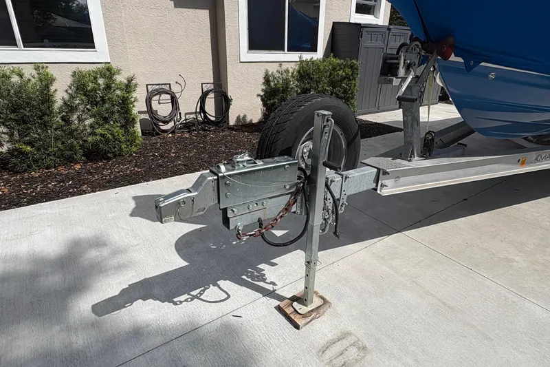 Slide: The Image of Trailer hitch of a 2019 Blue Wave 2800 Pure Hybrid boat parked on concrete driveway. - 27