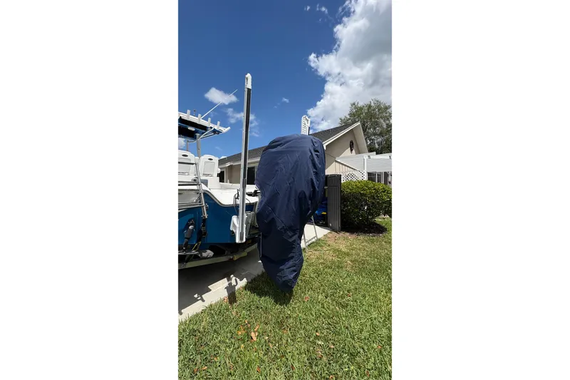 Slide: The Image of 2019 Blue Wave 2800 Pure Hybrid boat covered, parked on grass near a house. - 30