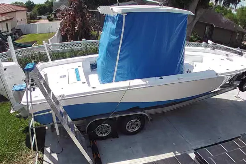 Slide: The Image of 2019 Blue Wave 2800 Pure Hybrid boat on trailer, covered with blue tarp. - 31