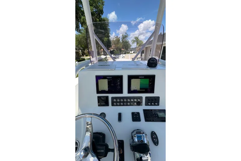 Slide: The Image of 2019 Blue Wave 2800 Pure Hybrid boat dashboard with navigation screens and controls. - 33