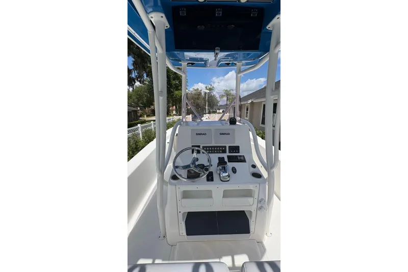 Slide: The Image of 2019 Blue Wave 2800 Pure Hybrid boat console with steering wheel and controls. - 41