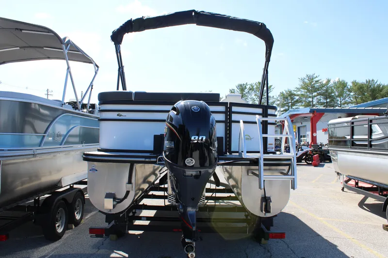 Slide: The Image of 2025 SunCatcher Select 20FC pontoon boat with Yamaha outboard motor, parked on trailer. - 10