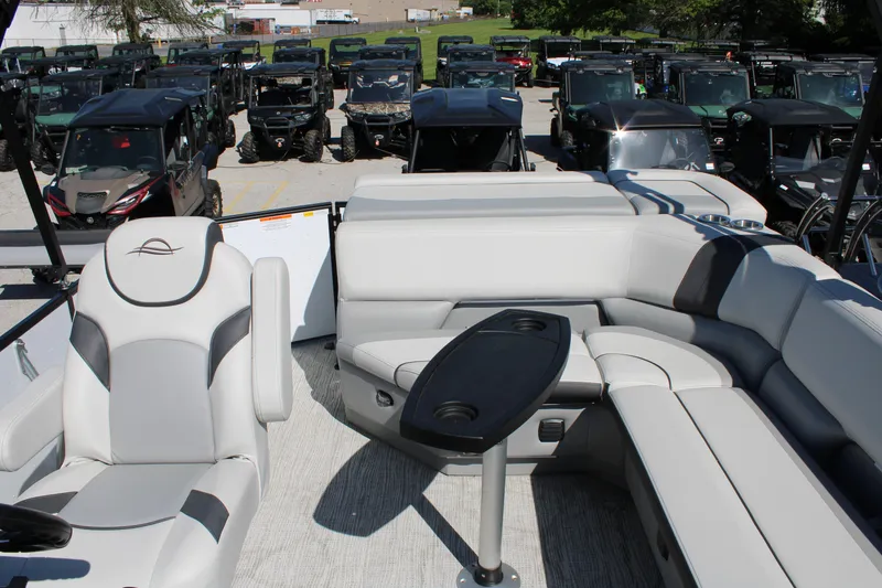 Slide: The Image of Luxurious 2025 SunCatcher Select 20FC pontoon boat interior with plush seating and table. - 13