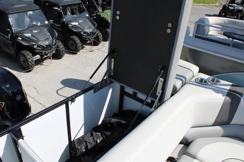 Slide: The Image of 2025 SunCatcher Select 20FC boat interior with storage compartment and cup holders. - 16