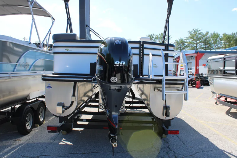 Slide: The Image of 2025 SunCatcher Select 20FC pontoon boat with Yamaha outboard motor, parked on trailer. - 20