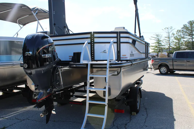 Slide: The Image of 2025 SunCatcher Select 20FC pontoon boat with Yamaha engine on trailer in parking lot. - 21