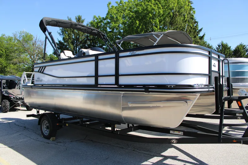 The Image of 2025 SunCatcher Select 20FC pontoon boat on trailer, parked outdoors. - 6