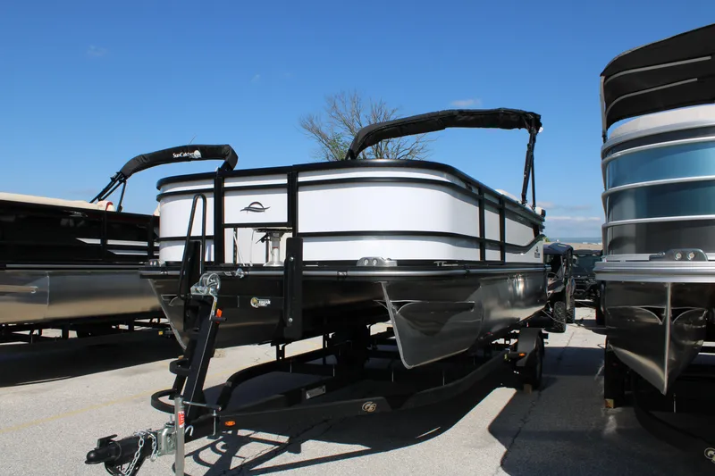 Slide: The Image of 2025 SunCatcher Select 20FC pontoon boat displayed outdoors on a trailer. - 8