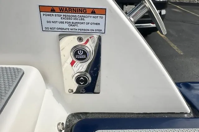 Slide: The Image of Power step control panel on 2026 Chaparral 6 SSX boat with warning label. - 15