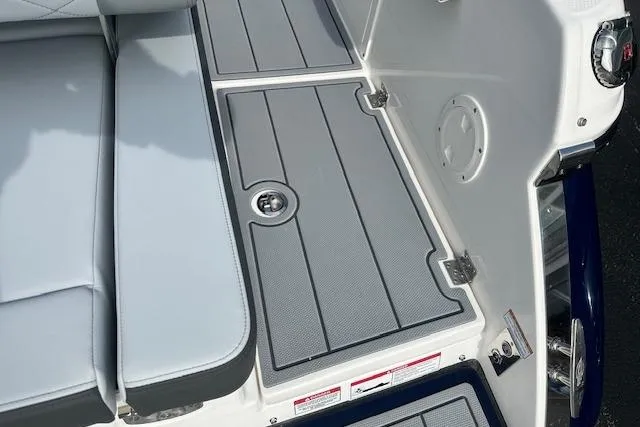Slide: The Image of 2026 Chaparral 6 SSX boat deck with gray non-slip flooring and cushioned seating. - 16