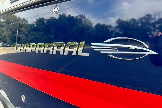 Slide: The Image of 2026 Chaparral 6 SSX boat logo on sleek blue and red exterior. - 2