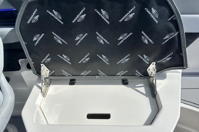 Slide: The Image of 2026 Chaparral 6 SSX boat storage compartment with branded interior lining. - 24