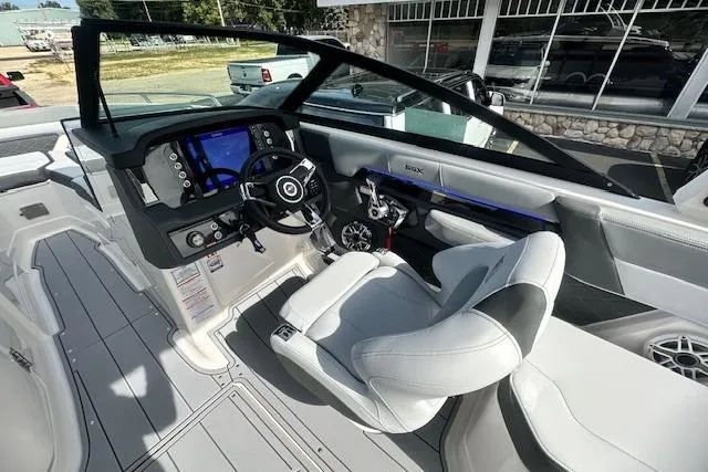 Slide: The Image of 2026 Chaparral 6 SSX boat interior with modern dashboard and comfortable seating. - 26