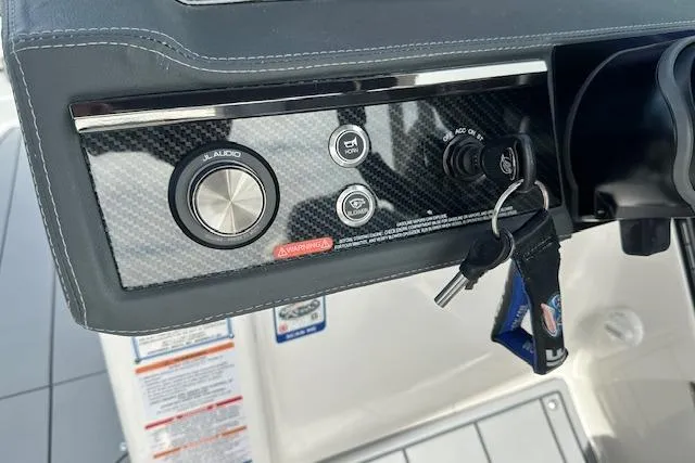 Slide: The Image of Control panel of 2026 Chaparral 6 SSX boat with keys and audio controls. - 31