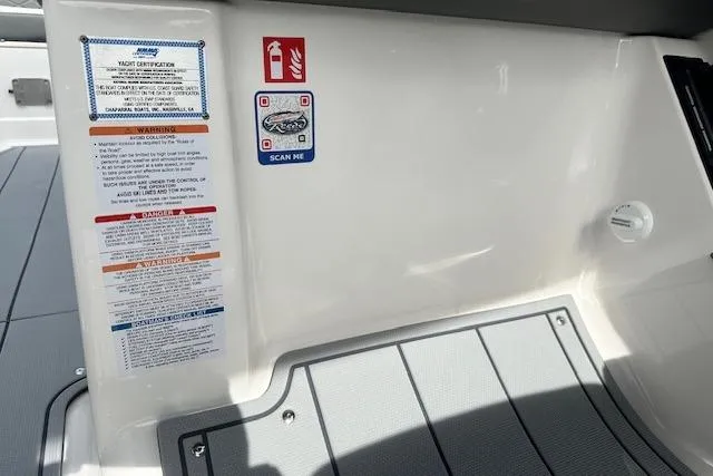 Slide: The Image of 2026 Chaparral 6 SSX boat interior with safety labels and QR code. - 33
