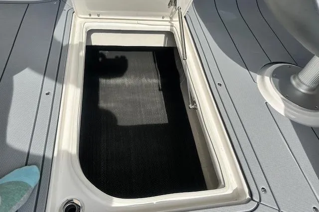 Slide: The Image of Open storage compartment on 2026 Chaparral 6 SSX boat deck. - 36