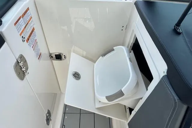 Slide: The Image of 2026 Chaparral 6 SSX boat interior with compact toilet compartment. - 39