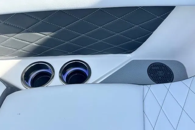 Slide: The Image of Interior of 2026 Chaparral 6 SSX with quilted upholstery and cup holders. - 44