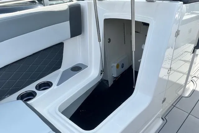 Slide: The Image of 2026 Chaparral 6 SSX boat interior, featuring seating and storage compartment. - 45