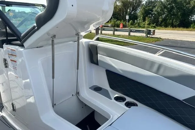 Slide: The Image of 2026 Chaparral 6 SSX boat interior with open storage compartment and seating. - 55