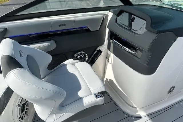 Slide: The Image of 2026 Chaparral 6 SSX boat interior with sleek white seating and modern dashboard design. - 58