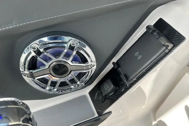Slide: The Image of 2026 Chaparral 6 SSX boat interior with JL Audio speaker and wireless charging pad. - 61