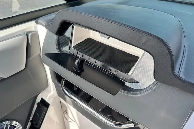 Slide: The Image of Interior detail of 2026 Chaparral 6 SSX boat, featuring a sleek dashboard compartment. - 64