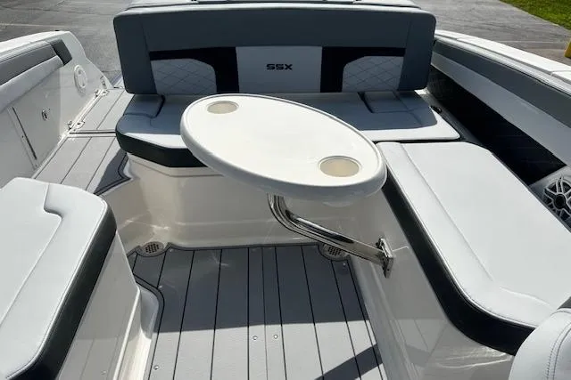 Slide: The Image of 2026 Chaparral 6 SSX boat interior with seating and a round table. - 67