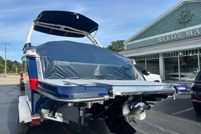 Slide: The Image of 2026 Chaparral 6 SSX boat with cover, parked near Reed's Marine. - 7
