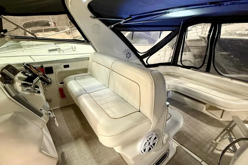 Slide: The Image of Interior of a 1995 Sea Ray Sundancer 370 boat with white seating and helm. - 10