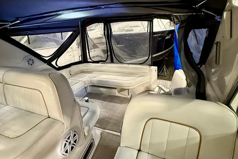 Slide: The Image of Interior of 1995 Sea Ray Sundancer 370 boat with white seating and canopy. - 12