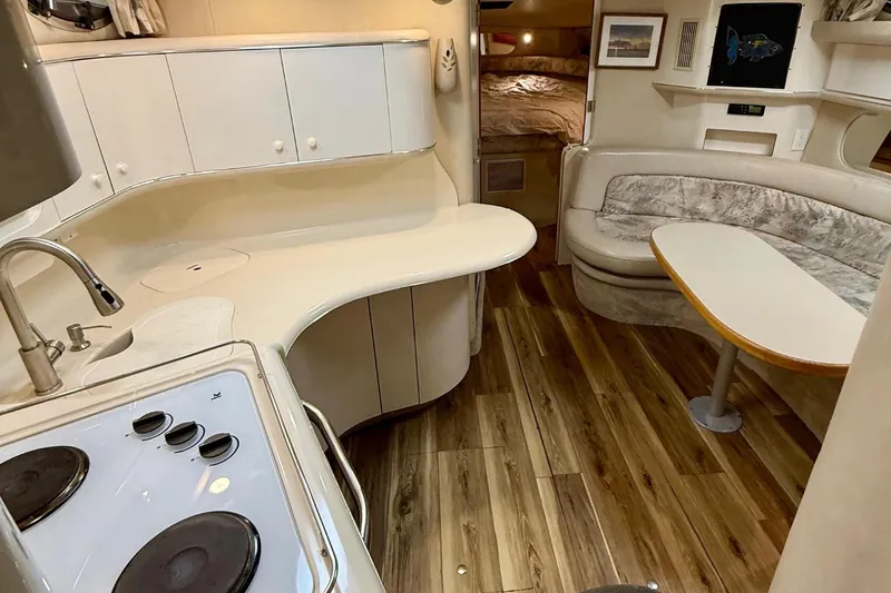 Slide: The Image of Interior of 1995 Sea Ray Sundancer 370 yacht with kitchen and seating area. - 13