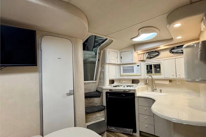 Slide: The Image of Interior of 1995 Sea Ray Sundancer 370 yacht, featuring modern kitchen and seating area. - 14