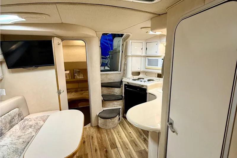 Slide: The Image of Interior of a 1995 Sea Ray Sundancer 370 yacht, featuring a cozy cabin and modern amenities. - 17