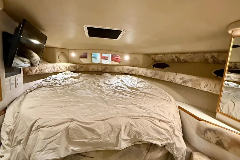 Slide: The Image of Interior cabin of 1995 Sea Ray Sundancer 370 with cozy bed and ambient lighting. - 19