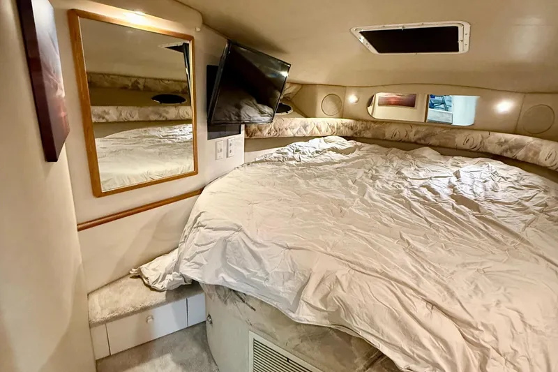 Slide: The Image of Cozy cabin interior of 1995 Sea Ray Sundancer 370 with bed and mirror. - 20